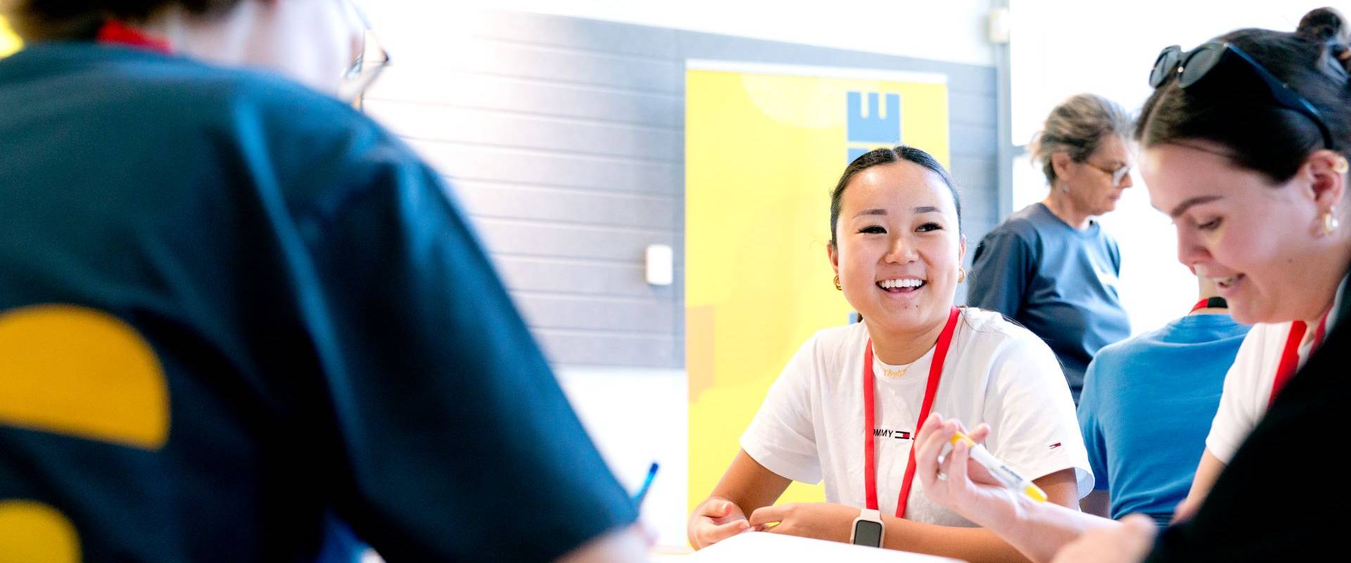 Program participant smiling whilst participating in a group activity