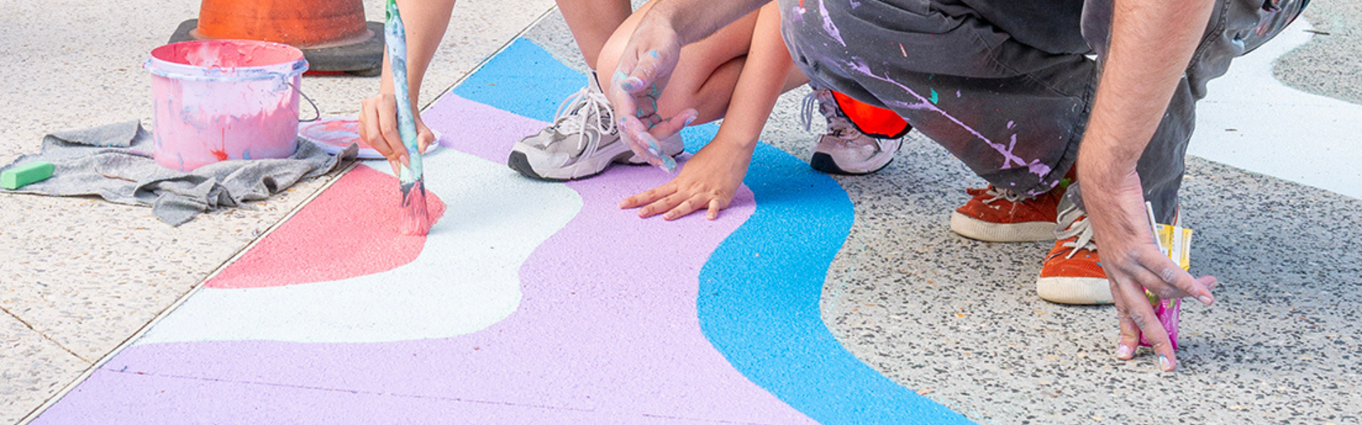 Participants painting the floor mural at the Wright Street makeover