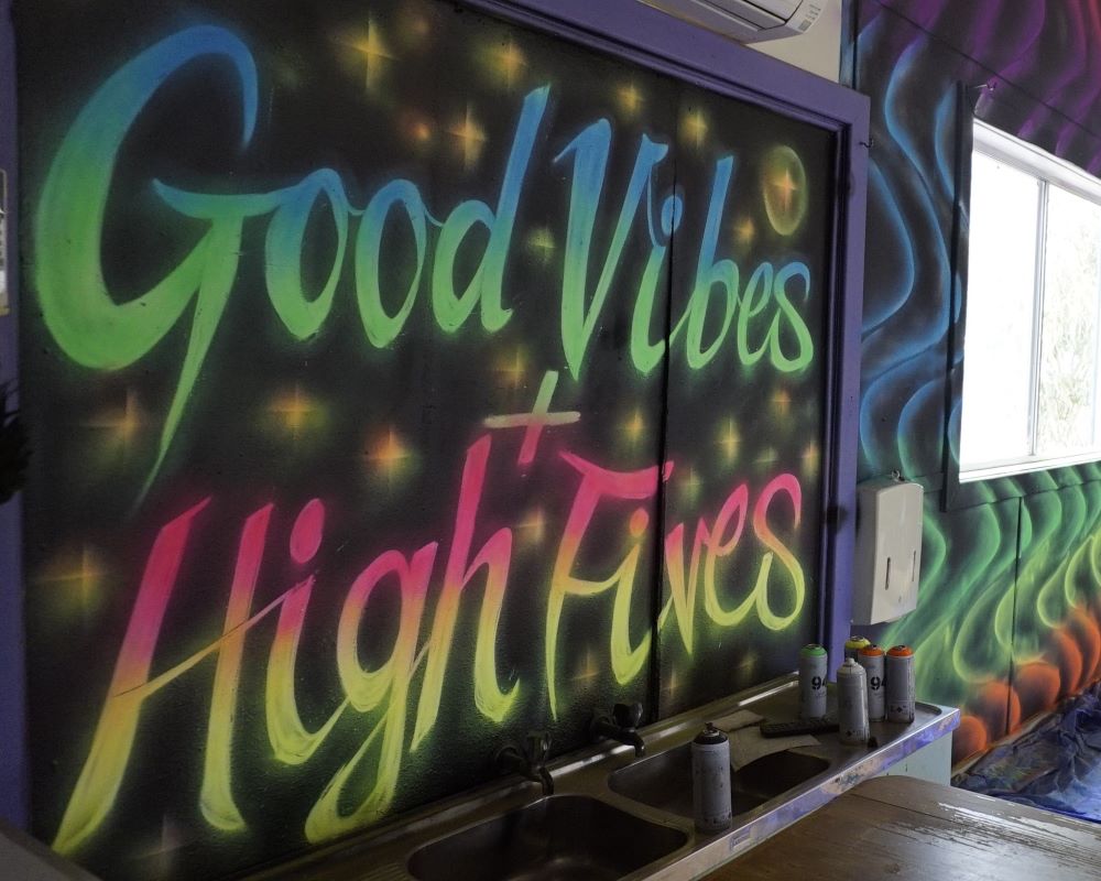 The Hub's neon mural injects colour and energy into the space.