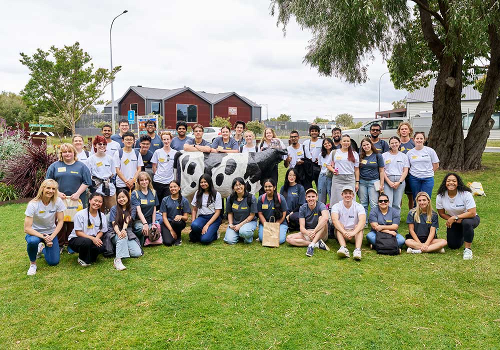 A large group of RAC Ignite participants are huddled together for a group photo