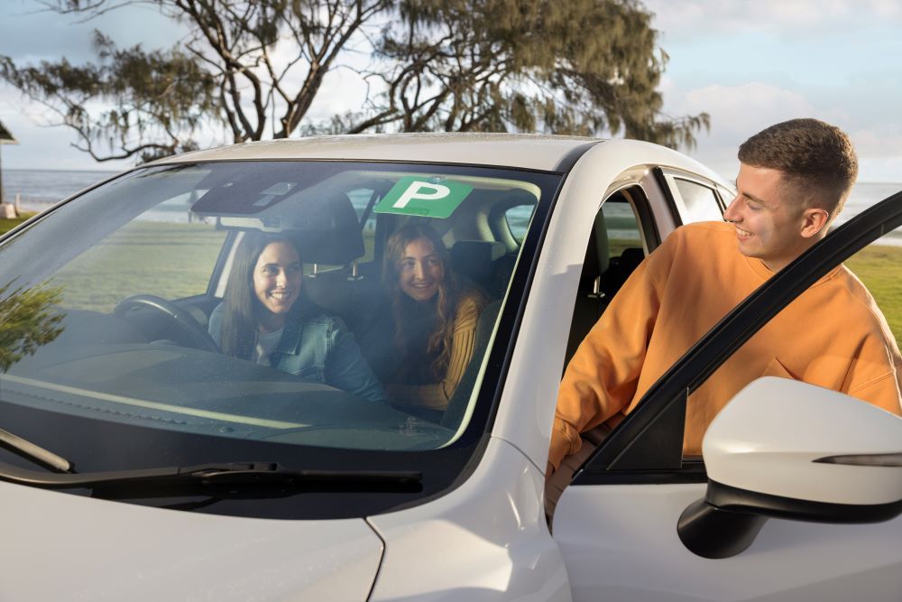 A group of young people get ready to take a drive together