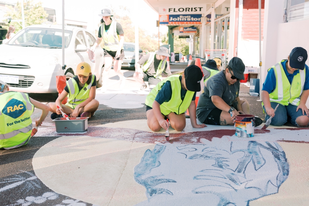 Young people painting a mural on the street in Kalamunda