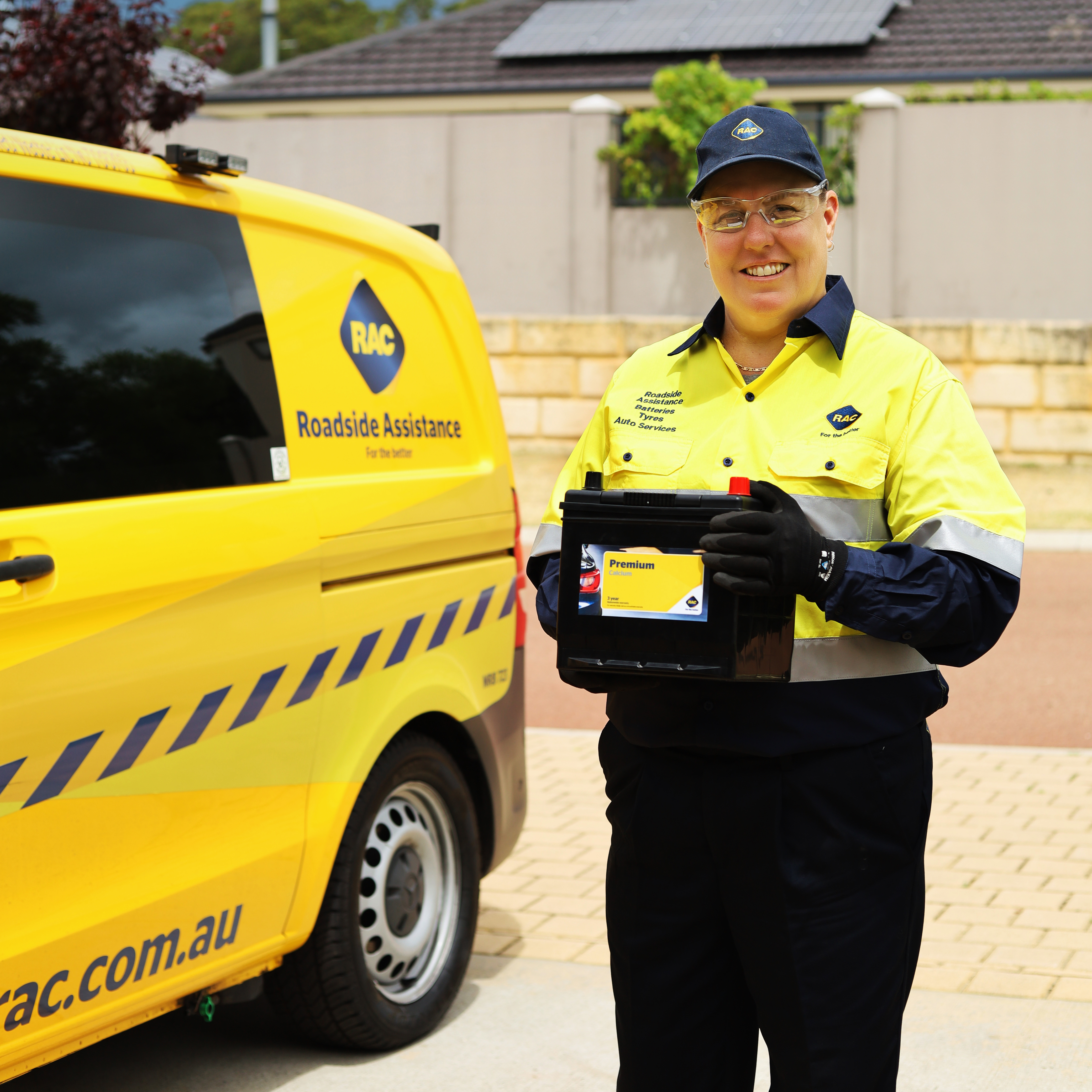 A female RAC Roadside Assistance patrol holding a replacement battery