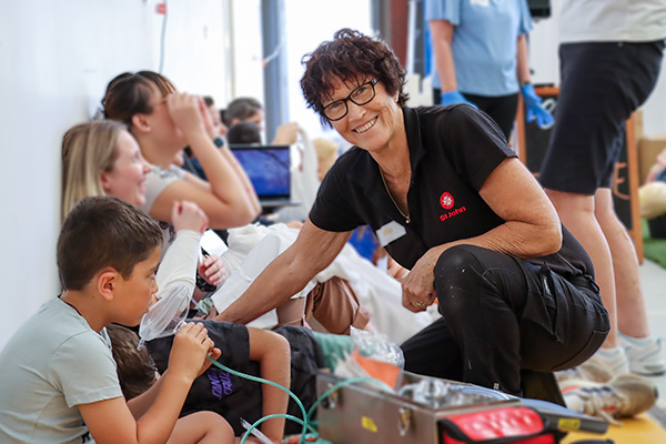 First Aid trainer supporting a young child in need.