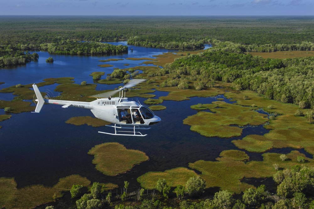 Helicopter in flight over the swamps in Rinyirru (Lakefield) National Park in Queensland