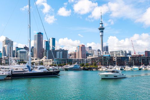 Auckland waterfront with boats in the marina and city skyline including the Sky Tower.