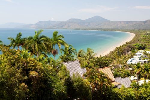 A quiet bay hugged by a white sanded beach and some tropical frosts