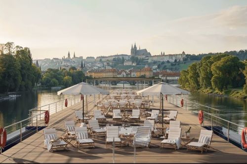 The top deck of a river cruise ship with seating and umbrellas