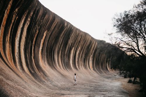 A traveller exploring the wave rock formation in Hyden. 