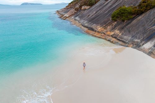 Aerial image of a traveller walking down Misery Beach.