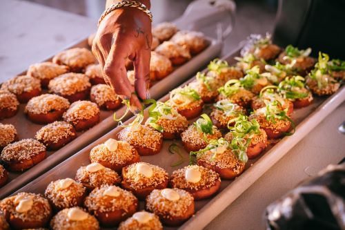 Close up of delicious finger food served on long plates.