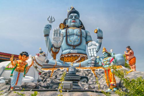 Large Shiva statue surrounded by colourful Hindu temple figures in Sri Lanka