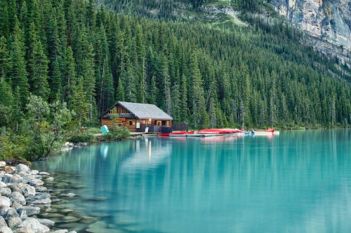 Boat House surrounded by lush forest by the turquoise waters of Lake Louise
