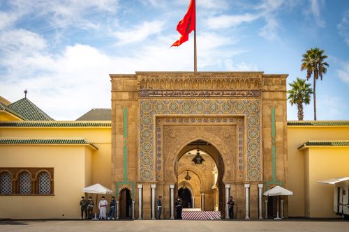 Ornate entrance to the Royal Palace in Rabat with guards standing outside.