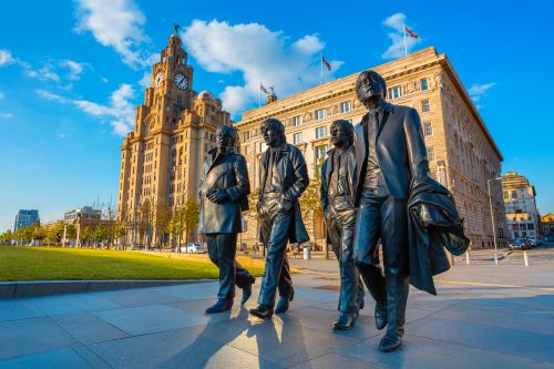 Bronze statue of the Beatles stands at the Pier Head on the side of River Mersey.