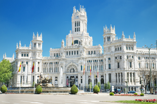 Palacio de Comunicaciones, a grand white landmark building in Madrid with ornate architecture and towers. 