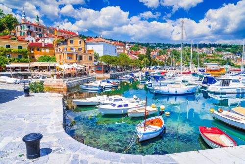 Colourful houses and boats on Adriatic Sea coastline. 