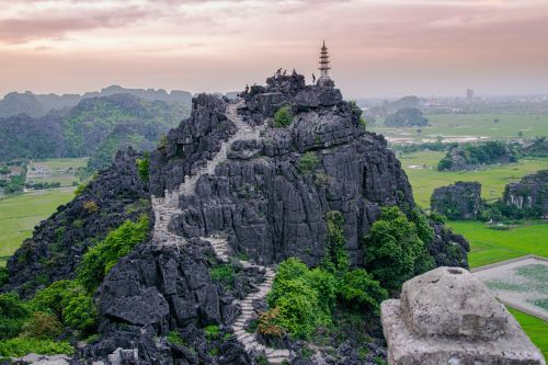 Top pagoda of Hang Mua temple high up on a hill. 