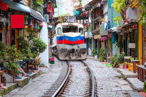 Train travelling through Hanoi’s famous Old Quarter railway street.
