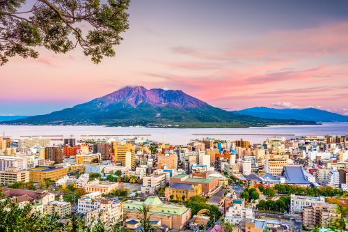 A skyline of Kagoshima in Japan with the Sakurajima Volcano in the background