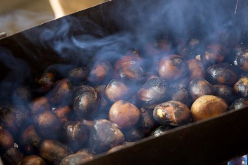 A closeup of Chestnuts steaming of a barbeque