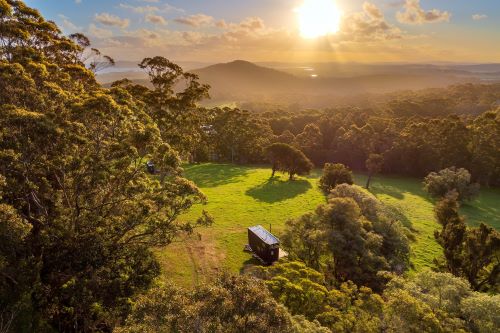 Aerial view of the Heyscape cabin at sunset in Denmark surrounded by pristine nature.