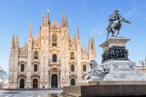 Milan cathedral with a bright blue sky in the background.
