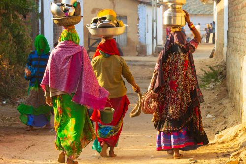 Village women headed to the wells with pots on head