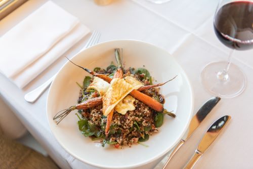 A beautifully arranged meal on a table set with white table cloth