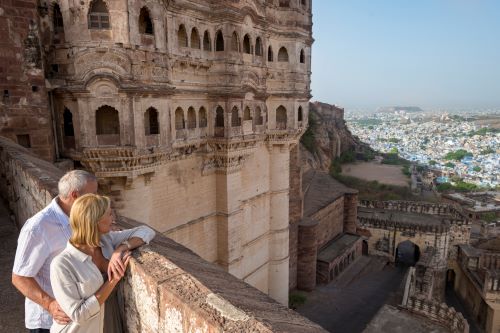 A couple standing at Mehrangarh Fort overlooking the city.