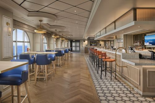 Modern cruise ship bar with seating and ocean views