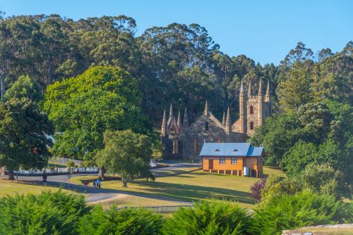 Church at Port Arthur Historic site in Tasmania surrounded by green trees. 