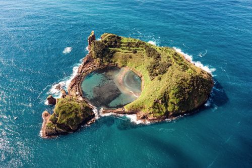 An island with a bay in the middle of the ocean