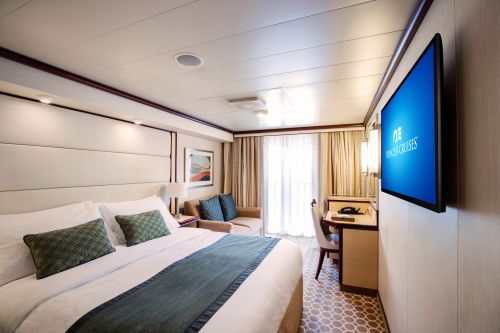 A cabin on a cruise ship with light coloured interiors