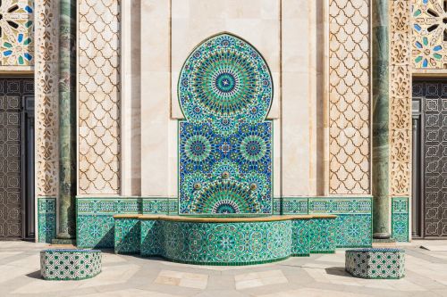 A mosque with green intricate tiles 