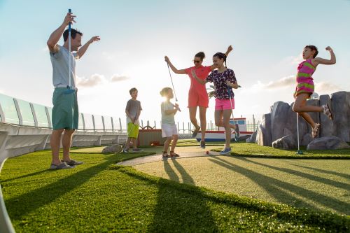 A family enjoying a round of mini golf aboard the vessel