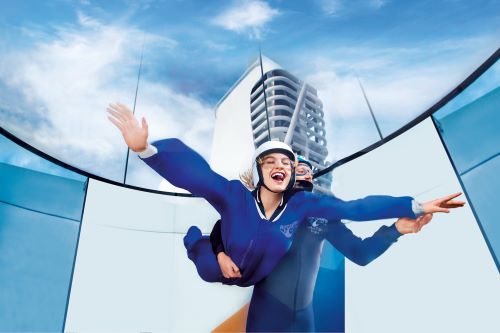 A woman trying out the iFly skydive simulator aboard the Royal Caribbean vessel