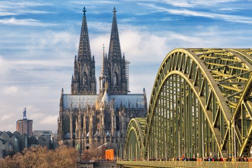 A Church in the background with a curved bridge in front 
