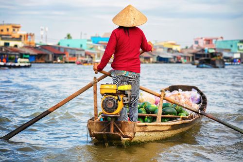 Woman selling watermelon at Floating market at Mekong.