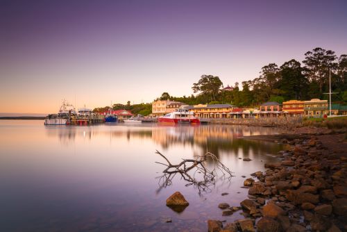 Strahan waterfront covered in purple sunset light