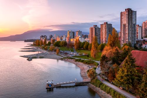 Vancouvers skyline at the coast coloured in purple by the sunset