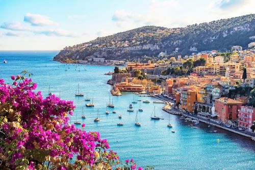 The vibrant blue waters of the Amalfi Coast with boats and yachts surrounded by the coastline and buildings 