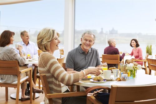 A couple enjoying each others company over a meal while onboard a ship