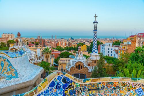 Colorful mosaic terraces in Park Güell overlooking the city and the sea