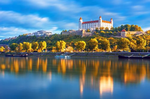 A castle ontop of hill overlooking a European River
