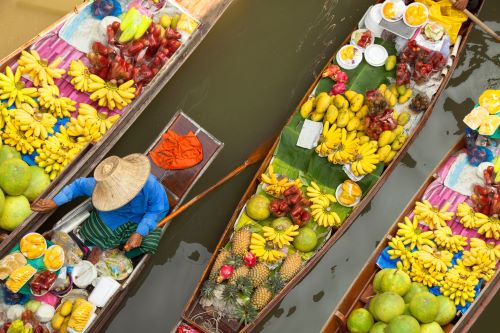 Thai long boats filled with fresh fruit to sell along the floating markets of Bangkok