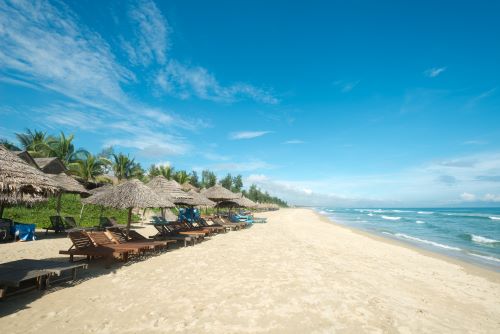 A serene, sandy shoreline with clear waters and peaceful atmosphere. 
