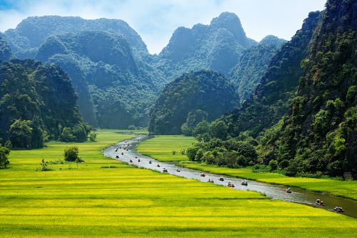 Scenic waterways of Ninh Binh, surrounded by limestone cliffs and lush greenery.